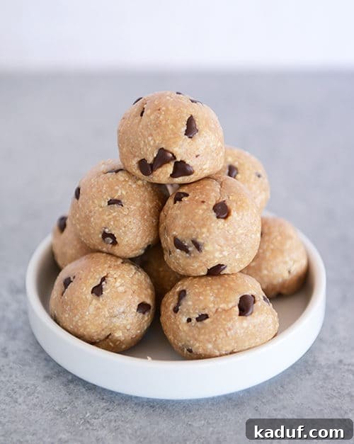 Scrumptious No Bake Cookie Dough Morsels 2 A stack of chocolate chip cookie dough bites on a small white plate, ready to be enjoyed.