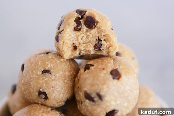 Scrumptious No Bake Cookie Dough Morsels 3 A stack of chocolate chip cookie dough bites, with a delicious bite taken out of the top one.