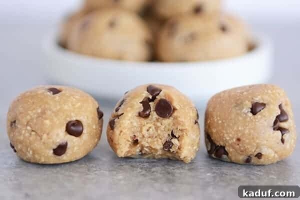 Scrumptious No Bake Cookie Dough Morsels 4 Three perfectly formed cookie dough bites lined up in a row, the middle one having a delicious bite taken out.