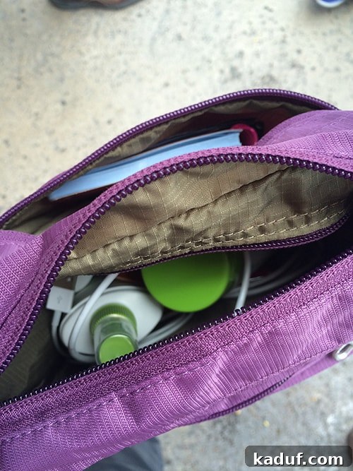 The Chill Girl's Disneyland Playbook 11 Top view of a stylish purple crossover travel bag, neatly packed.
