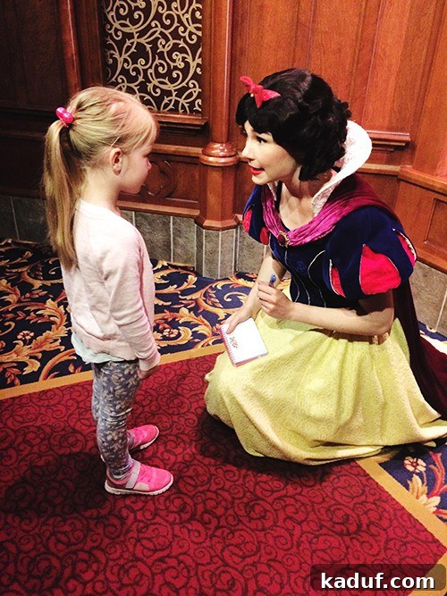 The Chill Girl's Disneyland Playbook 12 A little girl excitedly standing next to a Disney princess, ready for an autograph.