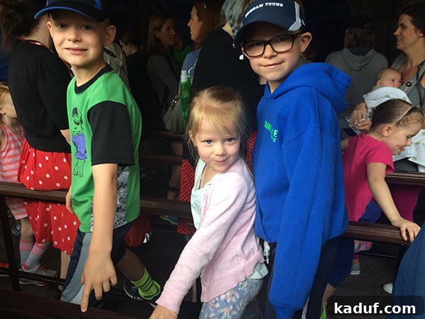 The Chill Girl's Disneyland Playbook 10 Little kids standing in a queue line at a Disneyland attraction, patiently waiting.