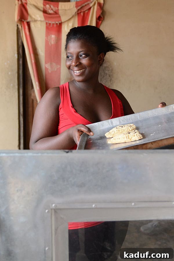 Answering Africa's Call 17 Agnes, a young entrepreneur, standing with her pastries