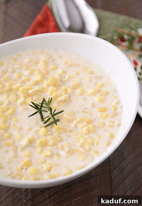Creamy Parmesan Corn Delight 2 A large oval white bowl filled with creamy Parmesan cream corn, ready to be served as a Thanksgiving side dish.