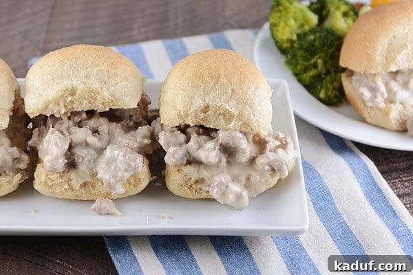 Cheesy turkey sloppy joe's on homemade rolls, on a white rectangular platter. 