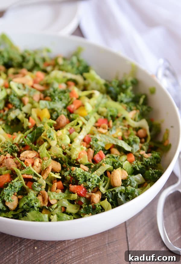 Honey Garlic Thai Chop 2 A large white bowl of colorful chopped Thai salad with mixed greens, vegetables, cashews, and a delicious dressing.