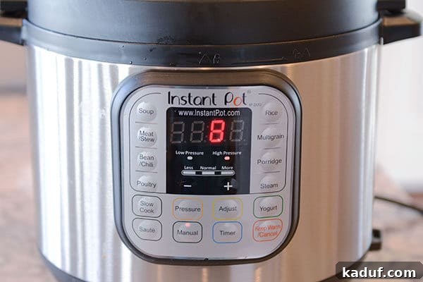 Velvety Instant Pot Mashed Potatoes 4 The front of an Instant Pot with 8 minutes left on the timer.