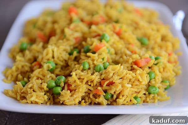 Instant Pot Indian Veggie Pulao 7 A beautifully presented white platter generously filled with flavorful Indian Vegetable Rice, ready to be served.