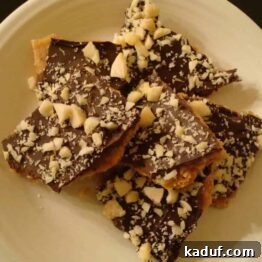 Close-up of mock chocolate macadamia toffee with a rich chocolate layer and crunchy macadamia nuts.