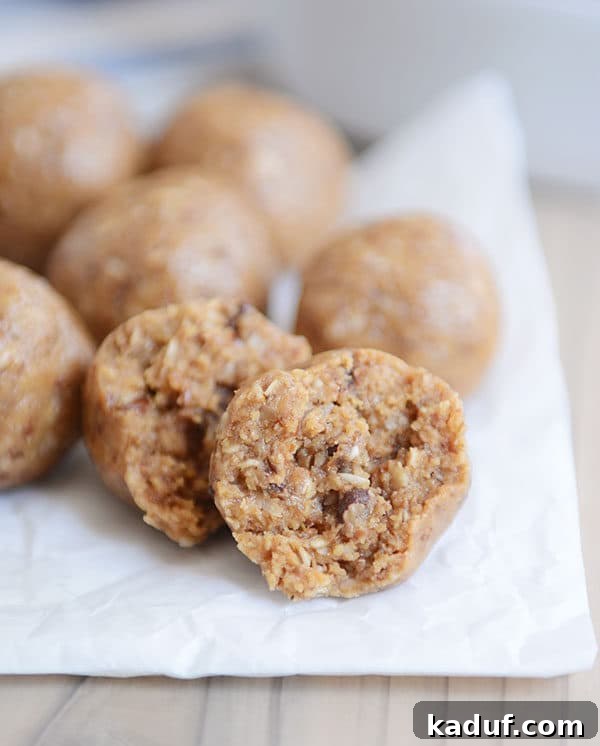 Delicious Protein Bites: Tailored to Your Taste 9 A parchment sheet covered with various protein balls, two in the foreground with bites taken out, showcasing their soft interior.