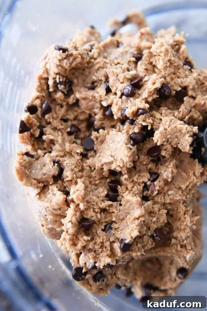 Delicious Protein Bites: Tailored to Your Taste 5 Top-down view of a chocolate chip peanut butter oat dough in a food processor, ready for shaping.
