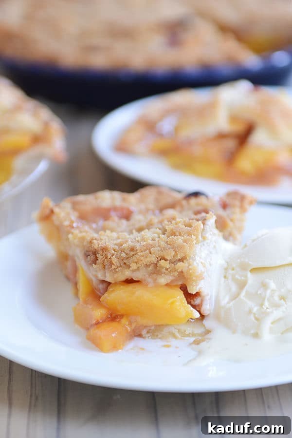 Summertime Peach Pie Perfection 3 A perfect slice of peach pie with a golden-brown crust and juicy peach filling, served alongside a scoop of melting vanilla ice cream on a white plate. A bite has been taken, revealing the exquisite texture.