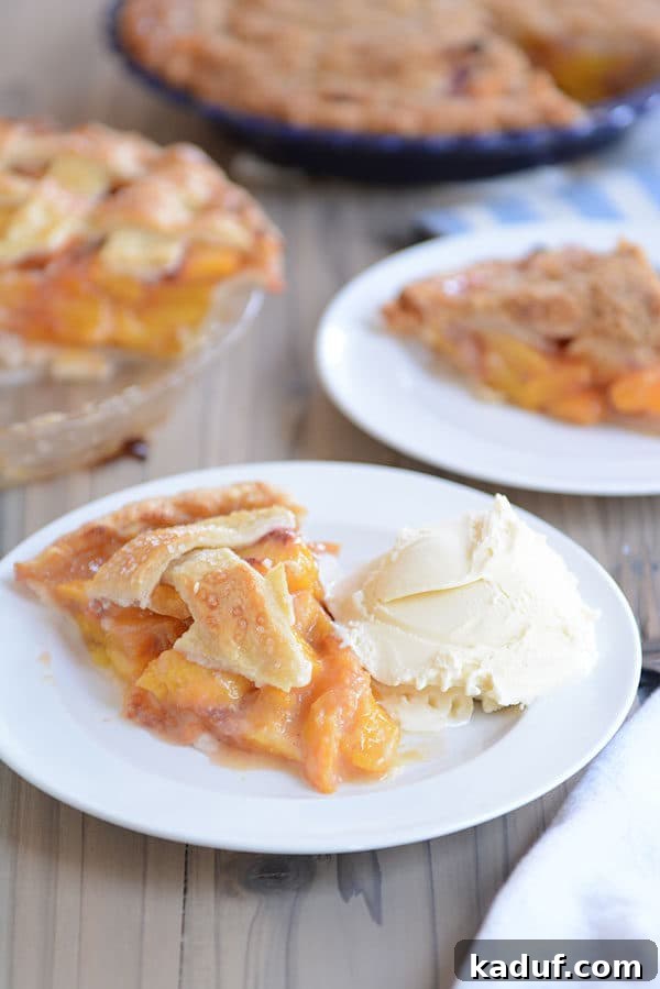 Summertime Peach Pie Perfection 7 A beautifully composed image featuring a slice of peach pie and ice cream on a white plate, placed in front of two complete peach pies in blue dishes.