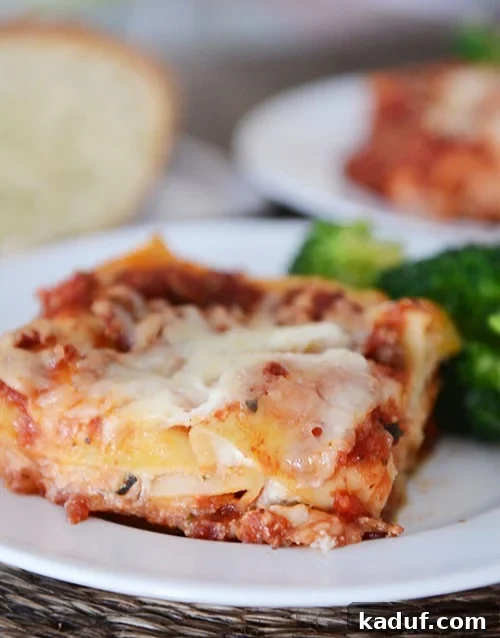 Mom's Signature Lasagna 3 A piece of lasagna and broccoli on a white plate. A generous portion of lasagna ready for serving.