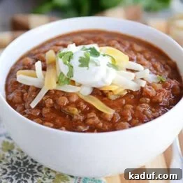 A tempting bowl of Instant Pot Lentil Chili, garnished and ready to be enjoyed.
