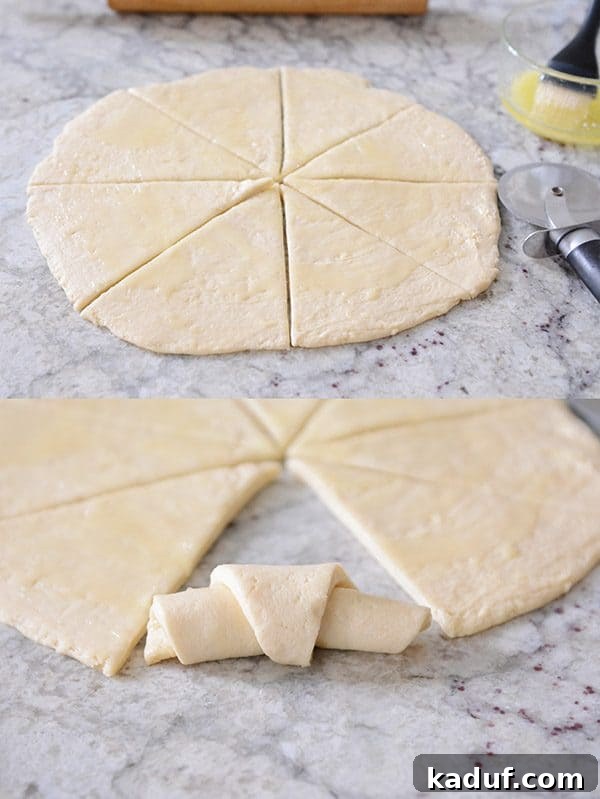 Easy Overnight Buttery Flaky Crescent Rolls 5 Prepared crescent roll dough, flattened and expertly cut into wedges, awaiting the rolling process to form crescent shapes.