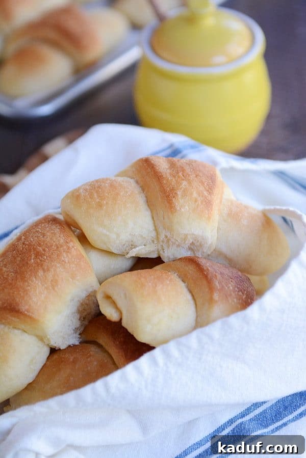Easy Overnight Buttery Flaky Crescent Rolls 6 A cozy napkin-lined basket overflowing with freshly baked, golden-brown crescent rolls, ready to be enjoyed.