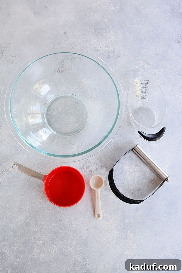 Pie Boot Camp: Gearing Up for Great Pies 3 Top view of a glass bowl, red measuring cup, spoon, and liquid measuring cup, all essential for pie making.