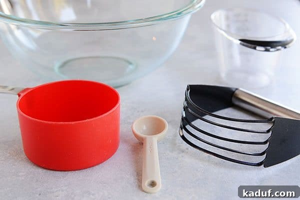 Pie Boot Camp: Gearing Up for Great Pies 4 A glass bowl, red measuring cup, teaspoon, pastry blender, and liquid measuring cup, basic tools for pie crust.