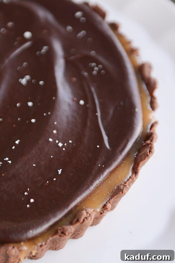 Rich Chocolate Caramel Tart 8 Top view of a beautifully presented whole chocolate caramel tart, ready to be sliced and served.