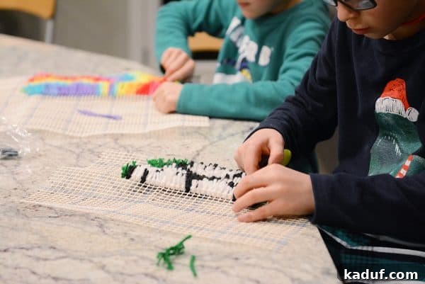 Friday's Musings 4 Child's hands working on a colorful latch hook kit, demonstrating focus and creativity.