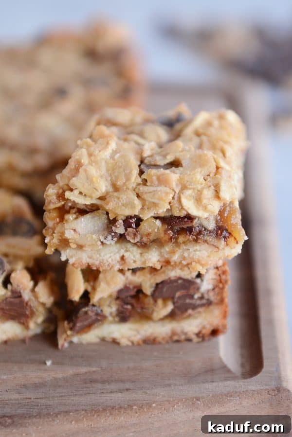 Buttery Caramel Oat Chocolate Chunk Shortbread Bars 2 Caramel oat chocolate chunk shortbread bar stacked on another bar.