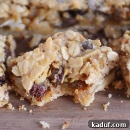 Bite taken out of caramel oat chocolate chunk shortbread bar.