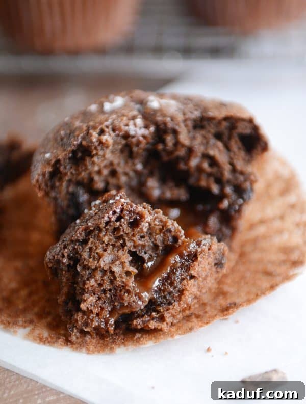 Another close-up of a halved double chocolate salted caramel muffin, highlighting the beautiful caramel surprise within and the tender texture.