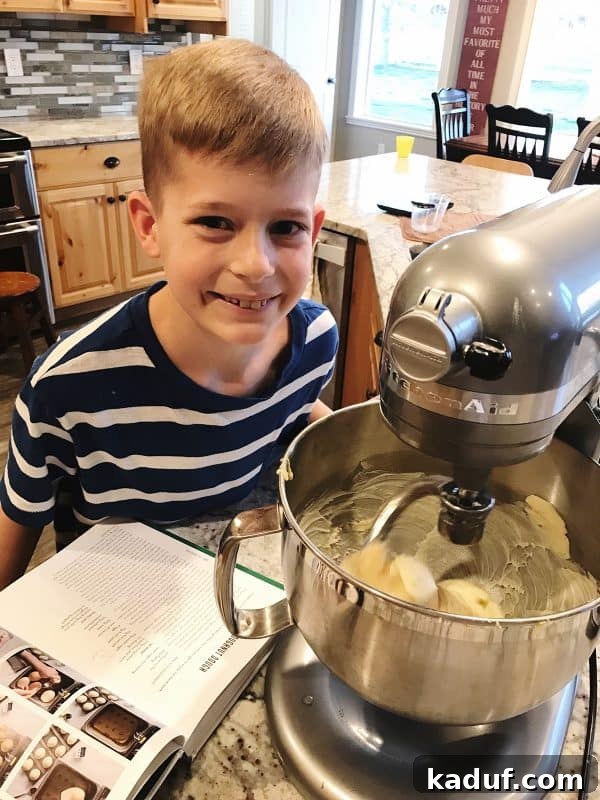 Friday Reflections 3 A child happily preparing homemade donuts from a cookbook, illustrating the joy of hands-on cooking and learning.
