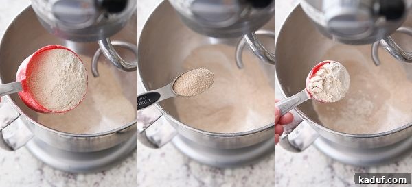 Effortless KitchenAid Small Batch Soft Fluffy Whole Wheat Bread 4 Flour, vital wheat gluten, and yeast being poured into a bowl of whole wheat bread dough, setting the stage for baking.