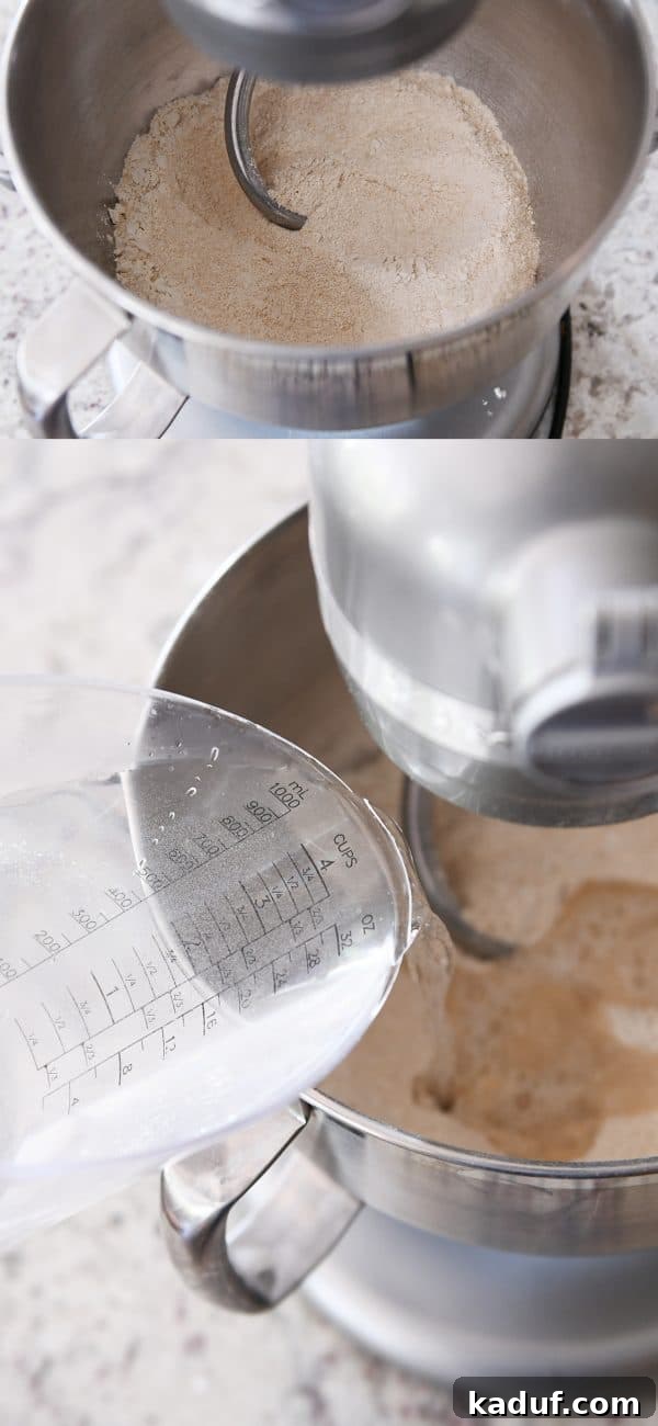 Effortless KitchenAid Small Batch Soft Fluffy Whole Wheat Bread 5 Water and flour getting mixed with a dough hook in a metal KitchenAid bowl, forming the initial sponge.