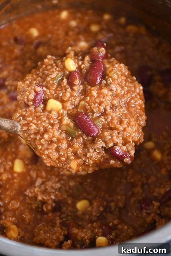 Versatile Quinoa Red Bean Chili Instant Pot and Slow Cooker 2 Ladleful of healthy Instant Pot quinoa red bean chili, steaming in a rustic bowl.