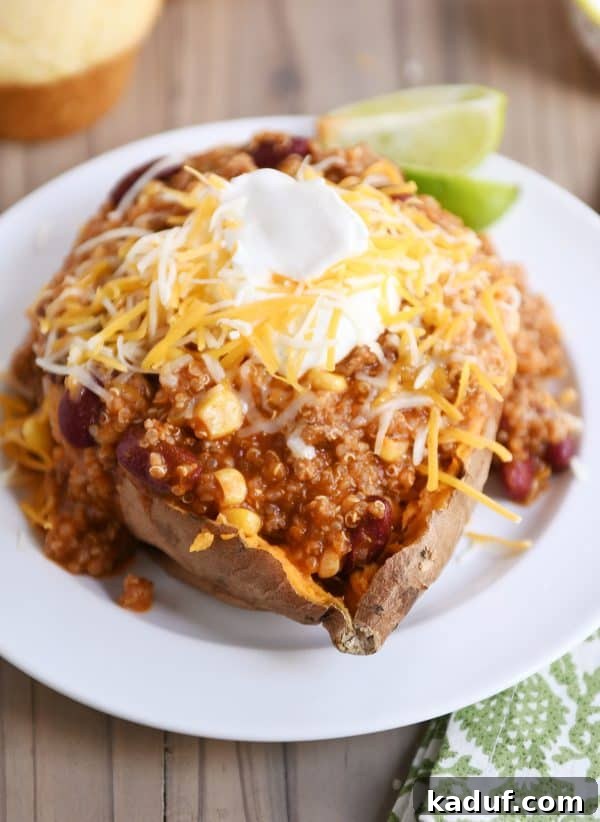 Versatile Quinoa Red Bean Chili Instant Pot and Slow Cooker 4 Baked sweet potato topped generously with Instant Pot quinoa red bean chili, sour cream, and shredded cheese.