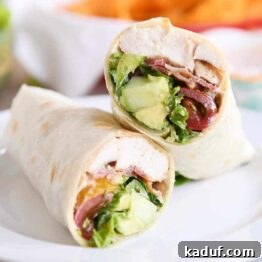 Weeknight Chicken BLT Wraps with Creamy Southwest Zing 5 Chicken BLT burritos cut in half on white plate.