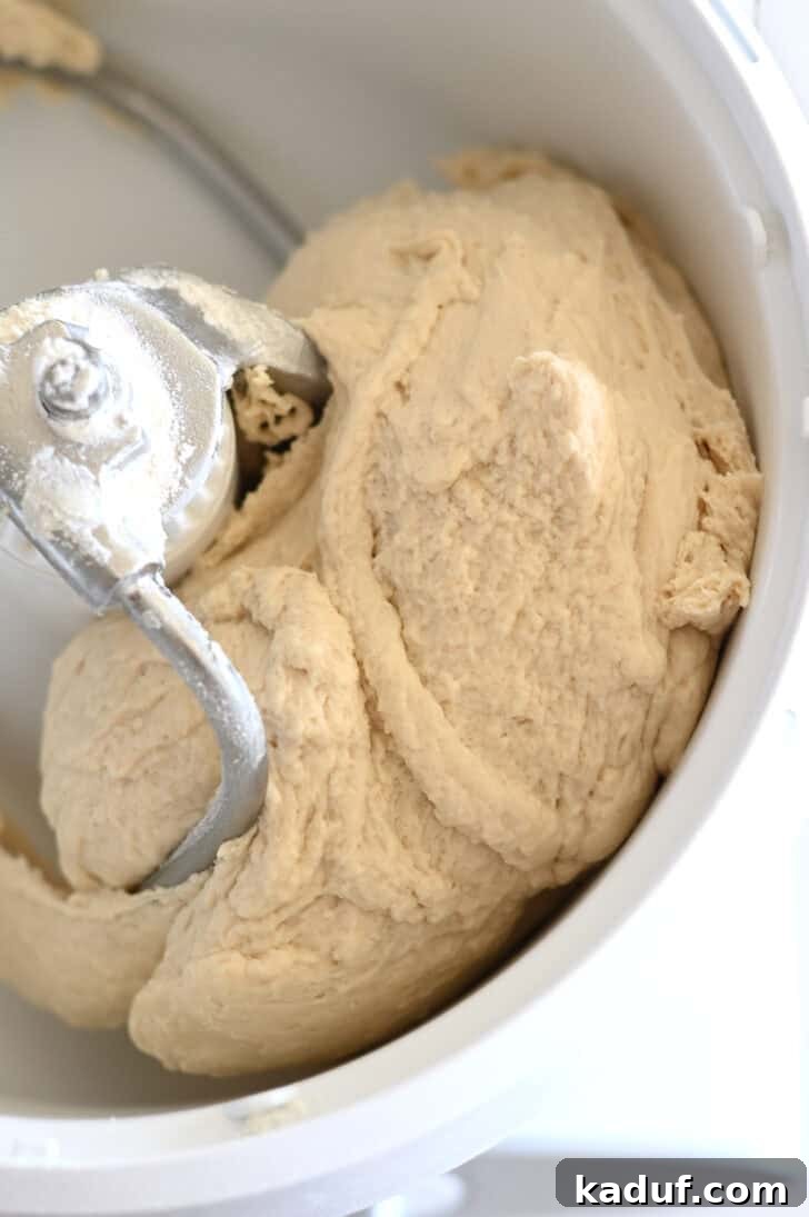 Quick Cheesy Parmesan Knots 4 Breadstick dough expertly mixed in a Bosch stand mixer, showcasing its smooth, elastic texture, ready for the next step of preparation.
