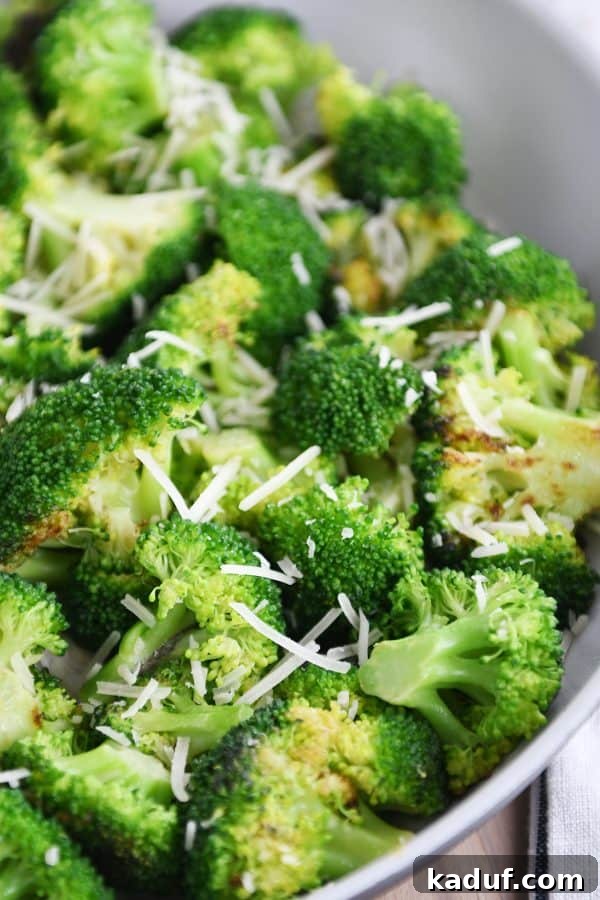 Three Quick Ways to Make Skillet Broccoli 2 Skillet with broccoli and Parmesan cheese, ready to be served.