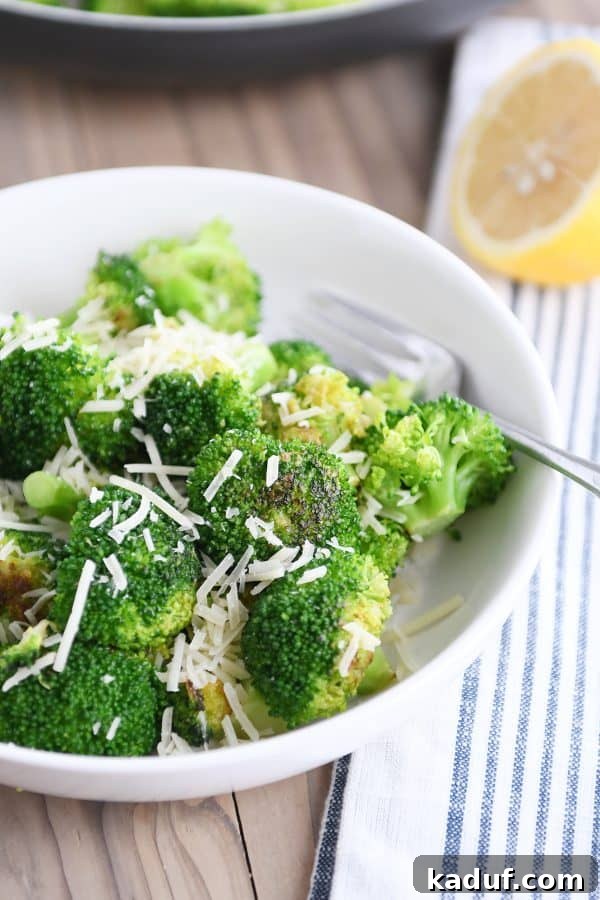 Three Quick Ways to Make Skillet Broccoli 3 White bowl filled with perfectly cooked skillet broccoli and a sprinkle of Parmesan.