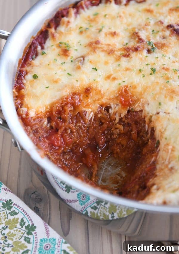 Effortless Weeknight Spaghetti Squash Casserole 6 The finished spaghetti squash spaghetti bake, golden and bubbly with cheese, still in the oven-safe pan.