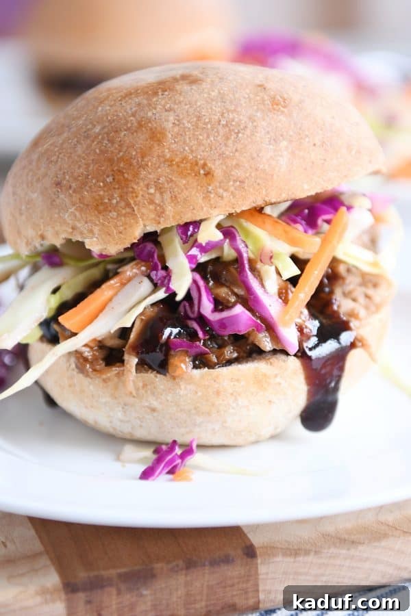 Effortless Honey Balsamic Pulled Pork Sandwiches Instant Pot and Slow Cooker Magic 4 A complete honey balsamic BBQ pork sandwich, served on a fluffy whole wheat bun with a side of refreshing coleslaw, ready to be enjoyed.