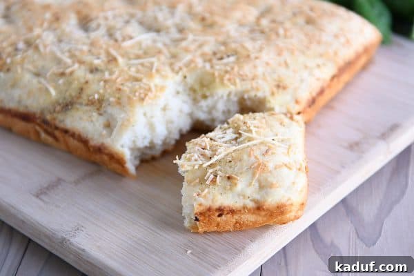 Super Simple Hand Mixed Focaccia 8 Easy focaccia bread with piece pulled apart from loaf.