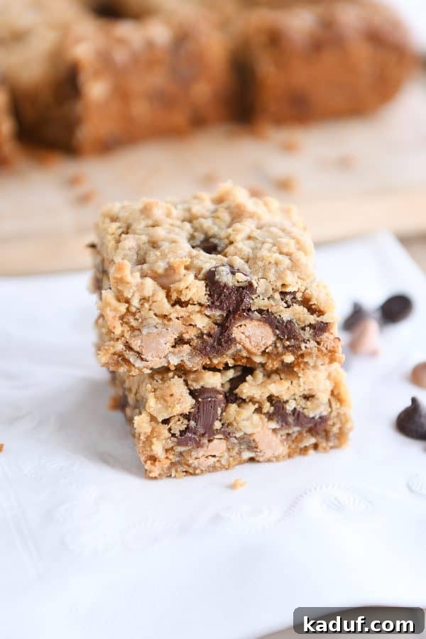 Two beautifully baked and cooled butterscotch PB monster cookie bars stacked on each other.