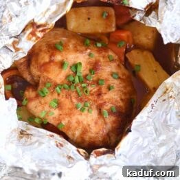 Tropical BBQ Chicken Foil Dinners 7 An opened BBQ Hawaiian chicken foil packet with succulent chicken, colorful peppers, and juicy pineapple inside.