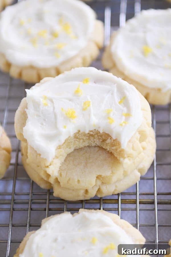Bite taken out of frosted lemon swig sugar cookies.