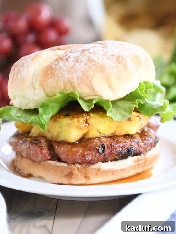 Tropical Teriyaki Turkey Burgers with Grilled Pineapple 2 Juicy Teriyaki Turkey Burgers with grilled pineapple, crisp lettuce, and a soft brioche bun.