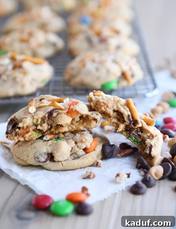 Peanut Butter Cosmic Crunch Cookies 2 Baked peanut butter kitchen sink cookies with one broken in half.