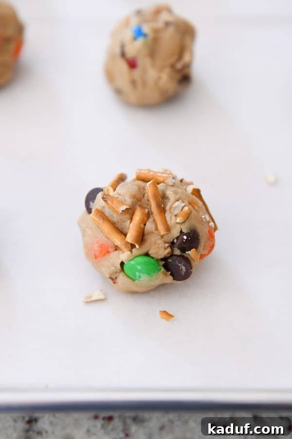 Peanut Butter Cosmic Crunch Cookies 4 Peanut butter kitchen sink cookie unbaked on baking tray.