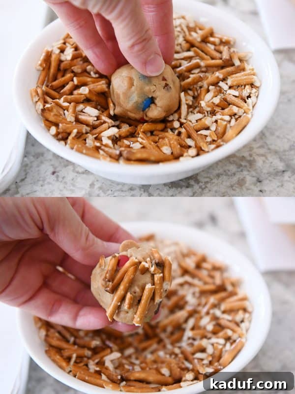 Peanut Butter Cosmic Crunch Cookies 7 Pressing crushed pretzels into unbaked peanut butter kitchen sink cookie dough ball.