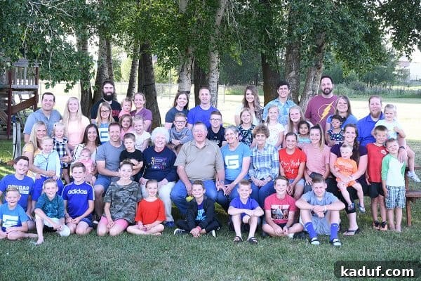 Friday Focus: Mastering the Summer Months 6 A group of smiling family members gathered together, enjoying a beautiful outdoor setting at a lodge.