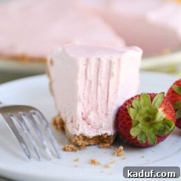 Pink Lemonade Strawberry Bliss Pie 6 A smaller image of a half-eaten slice of frozen strawberry lemonade pie, perfect for recipe cards.