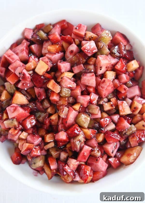 Vibrant Fruit Salsa with Honey-Kissed Cinnamon Crisps 5 Top down view of white shallow bowl with mixed fruit salsa.